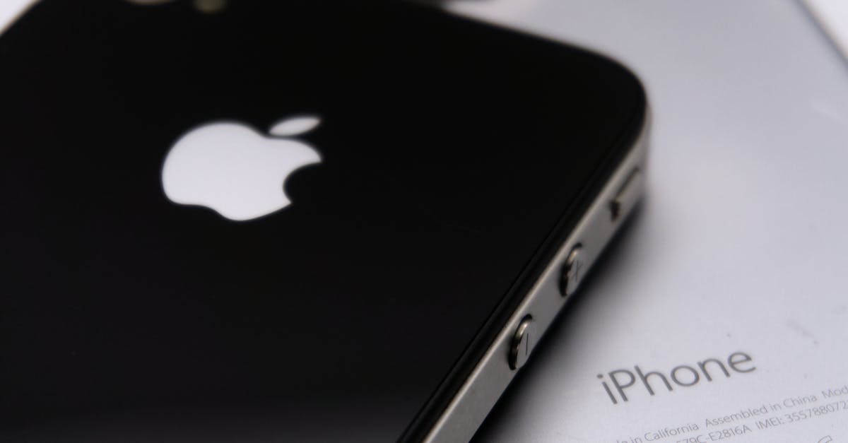 Two Apple smartphones photographed in close-up against a neutral background, showing the rear Apple logo and unibody design