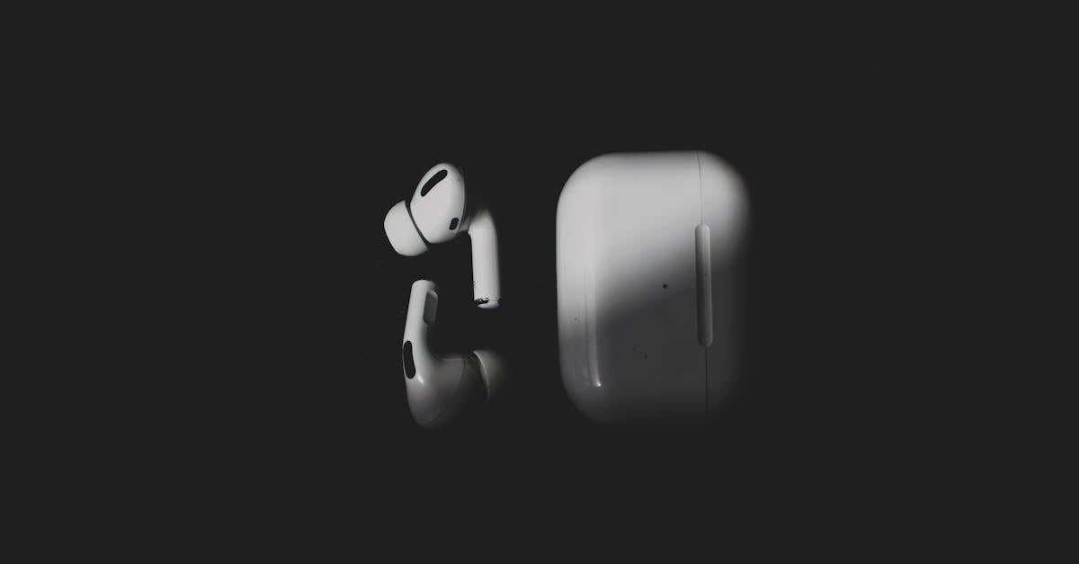 Apple AirPods Pro earbuds in their charging case on a dark surface
